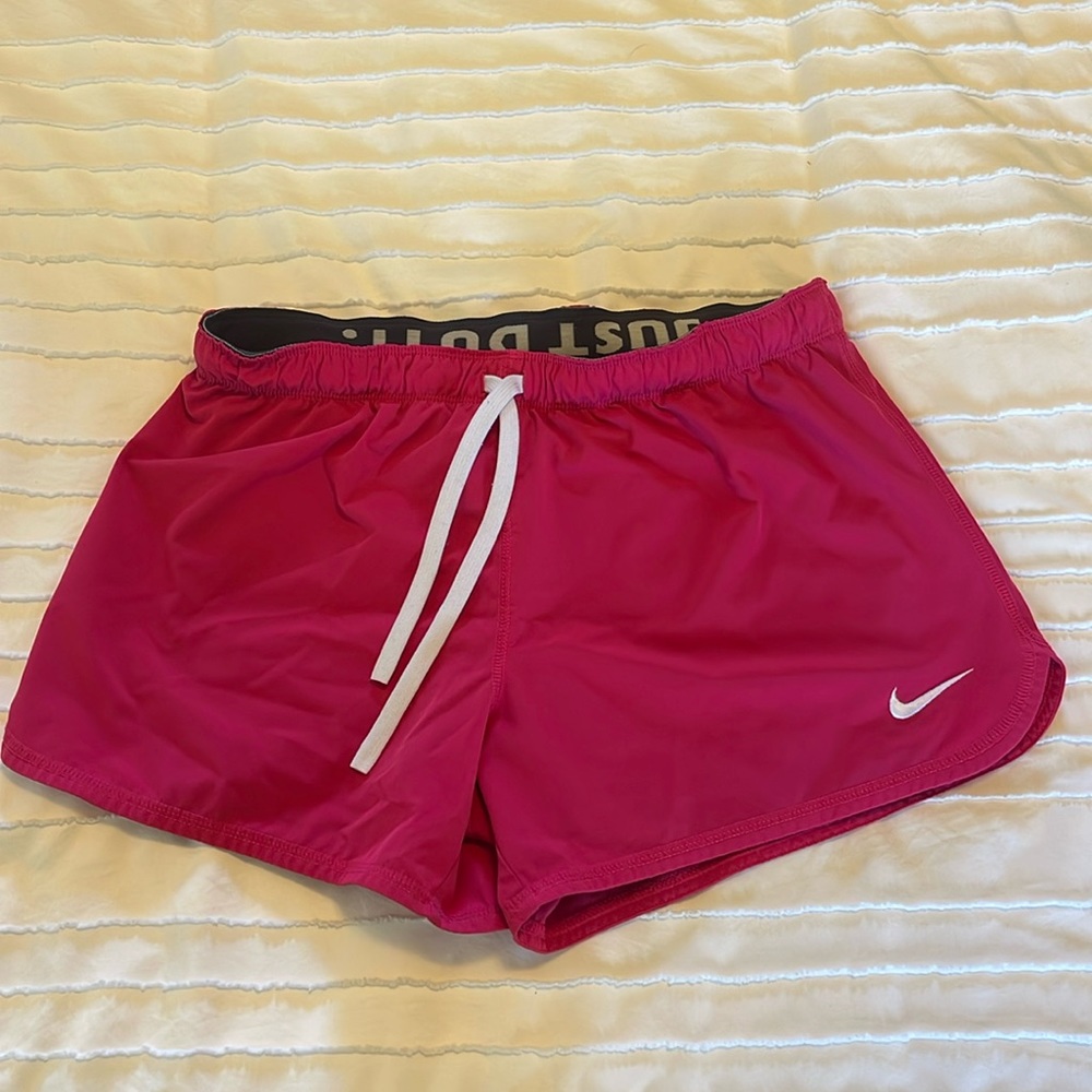 Pink Nike workout shorts with built in spandex. lightly worn size medium.